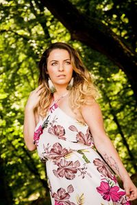 Portrait of woman standing against plants