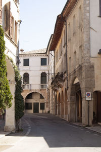 Street amidst buildings in city against clear sky