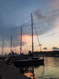 Sailboats in marina at sunset