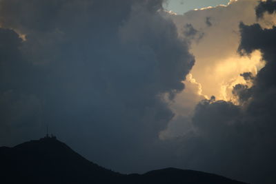 Low angle view of silhouette mountains against sky at sunset