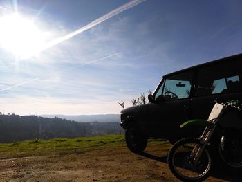 Vintage car on landscape against sky