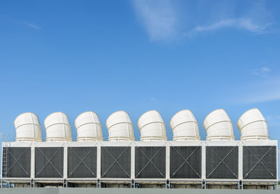 Low angle view of factory against blue sky