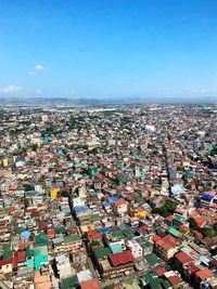 High angle view of townscape against blue sky