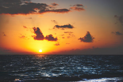 Scenic view of sea against romantic sky at sunset