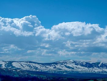 Scenic view of snowcapped mountains against sky