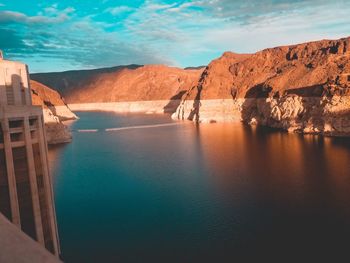 Scenic view of sea by rock formation against sky