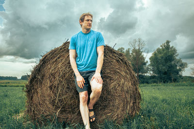 Full length of man standing on field against sky