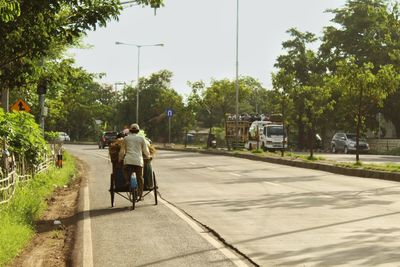 People riding bicycle on road