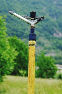 Close-up of wooden post on field