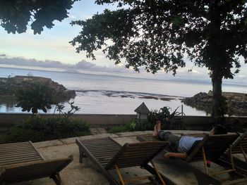 View of people sitting by swimming pool