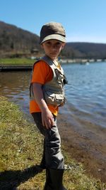 Portrait of boy standing at lakeshore