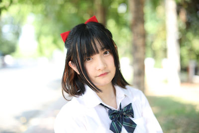 Portrait of young woman standing outdoors