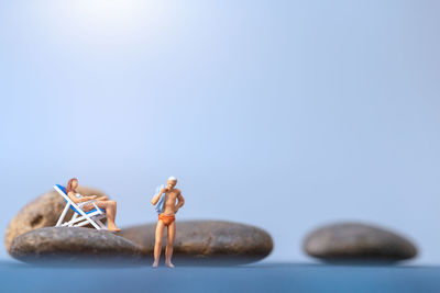 Close-up of figurine on table against blue background