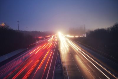 High angle view of light trails on road at night