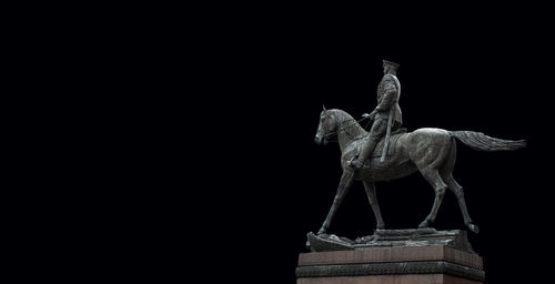 Low angle view of statue against clear sky at night