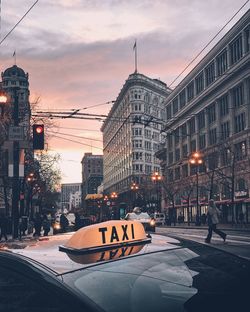 Taxi on street in city during sunset