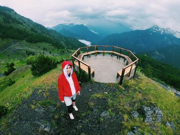 High angle portrait of woman standing on mountain