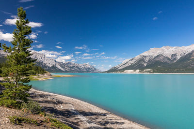 Scenic view of cline river and mountains against blue sky