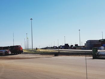 Cars on street against clear sky