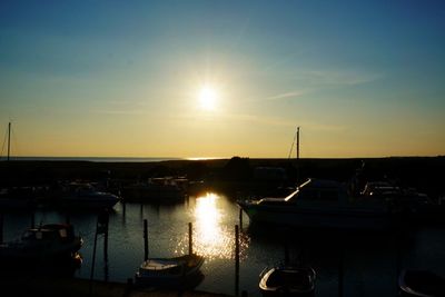 Boats moored at sunset