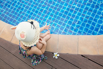 High angle view of woman sitting in swimming pool