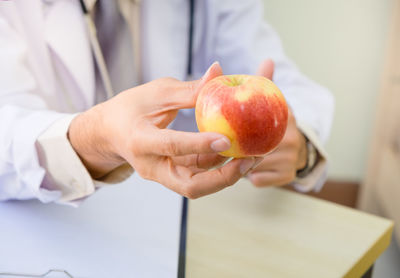 Close-up of hand holding apple