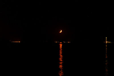 Scenic view of sea against clear sky at night