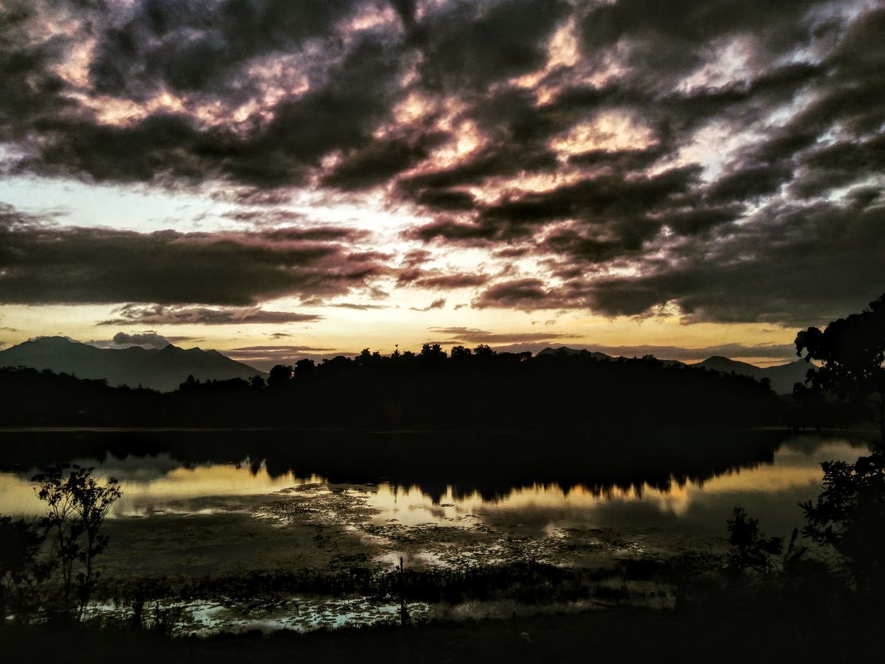 SCENIC VIEW OF LAKE AGAINST ORANGE SKY