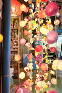 Low angle view of lanterns hanging on ceiling at night