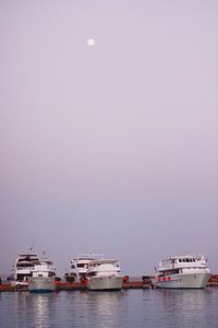 Cruise ships on sea against clear sky