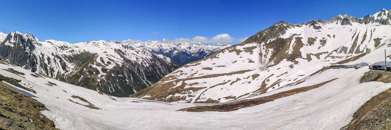 Ultra wide panorama from the nufenenpass with snowy mountains