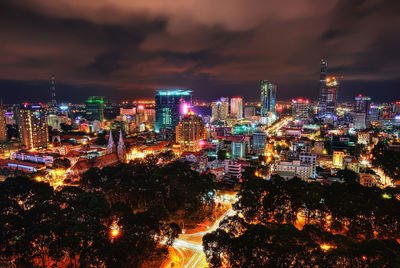 High angle view of illuminated buildings against sky at night