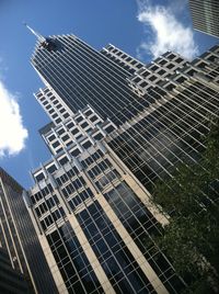 Low angle view of modern building against cloudy sky