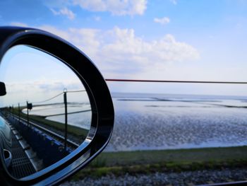 Reflection of sky on side-view mirror