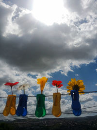 Close-up of multi colored umbrellas on beach against sky