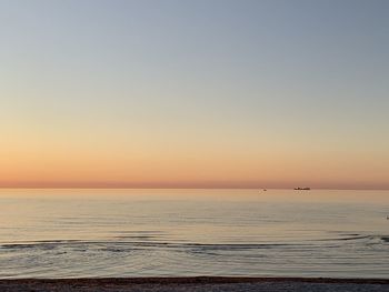 Scenic view of sea against clear sky during sunset