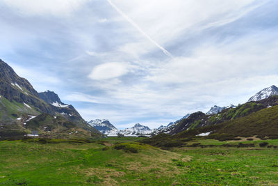 Scenic view of mountains against cloudy sky