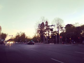 Cars on road in city against sky