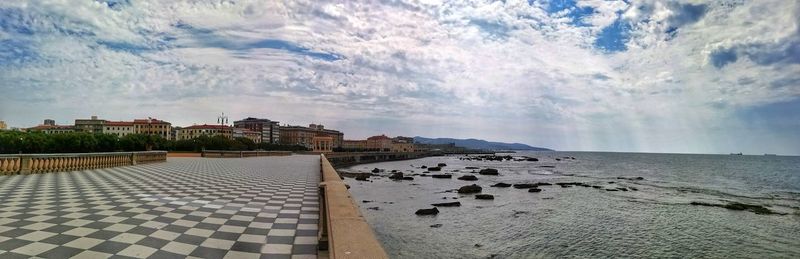 Panoramic view of beach and buildings against sky