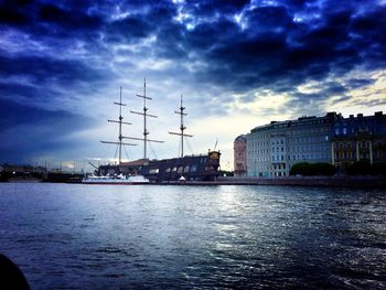 View of harbor against cloudy sky at sunset