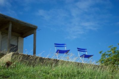 Low angle view of beach against blue sky