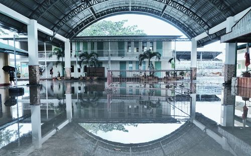 Reflection of chairs in swimming pool