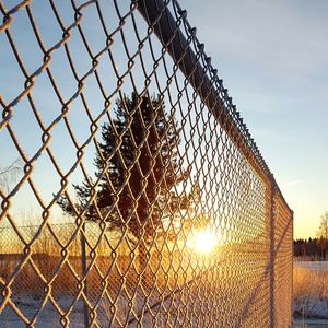 Low angle view of chainlink fence against sky