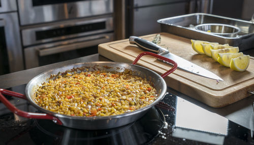 Close-up of paella in container on kitchen counter at restaurant