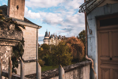 Trees and buildings against sky