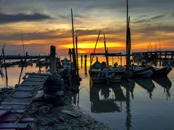 Boats in marina at sunset