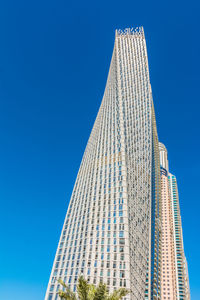 Low angle view of modern building against clear blue sky