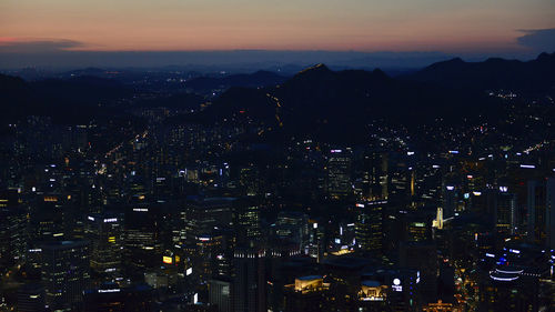 High angle view of illuminated buildings in city at night