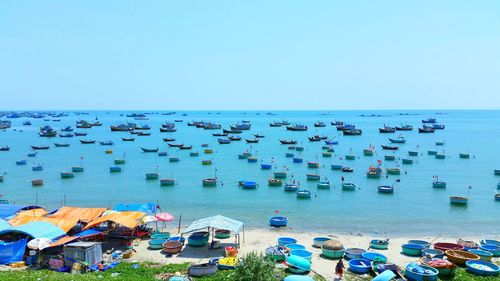 High angle view of sailboats moored in sea against clear sky