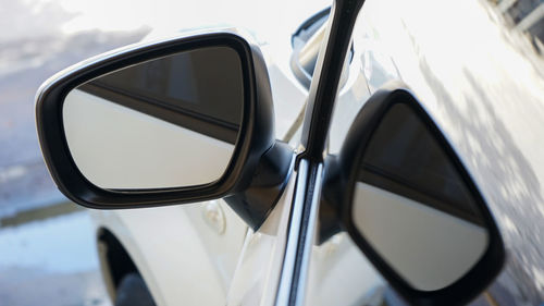 Close-up of sunglasses on side-view mirror